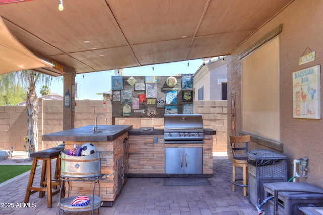 2115 N Cougar Ct, Casa Grande, AZ 85122 - view of patio / terrace with a sink, grilling area, fence, and exterior kitchen
