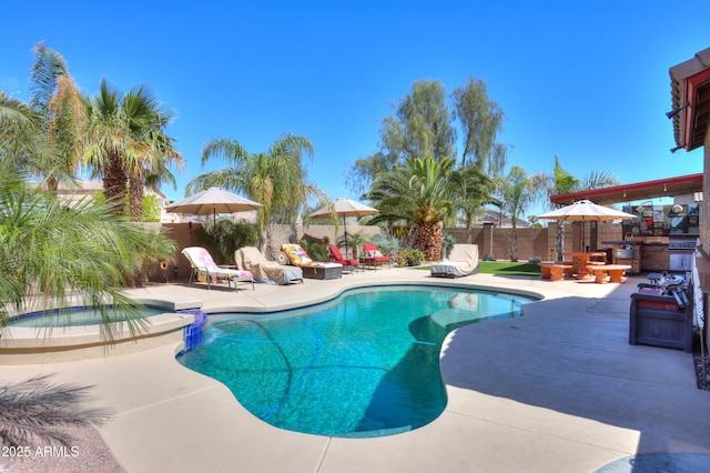 2115 N Cougar Ct, Casa Grande, AZ 85122 - view of pool with a patio area, a pool with connected hot tub, and a fenced backyard