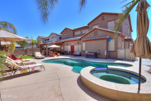 2115 N Cougar Ct, Casa Grande, AZ 85122 - view of swimming pool with a patio area, fence, and a pool with connected hot tub