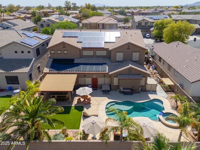 2115 N Cougar Ct, Casa Grande, AZ 85122 - exterior space featuring a residential view, a pool with connected hot tub, a patio area, and roof mounted solar panels