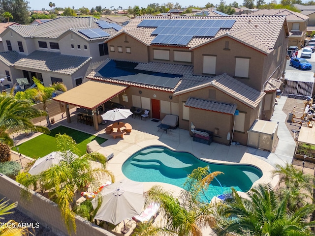 2115 N Cougar Ct, Casa Grande, AZ 85122 - back of property with solar panels, a tiled roof, a fenced backyard, a patio, and a residential view