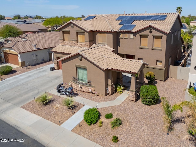 2115 N Cougar Ct, Casa Grande, AZ 85122 - mediterranean / spanish house featuring driveway, solar panels, a tile roof, stucco siding, and fence private yard