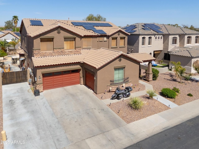 2115 N Cougar Ct, Casa Grande, AZ 85122 - view of front of property with stucco siding, driveway, stone siding, a tiled roof, and roof mounted solar panels