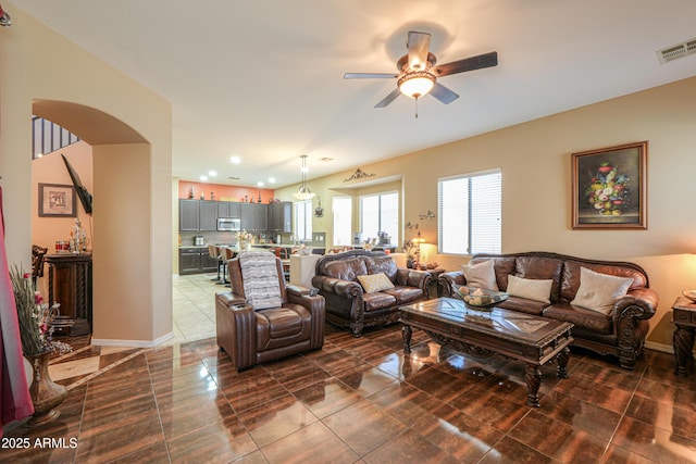 2115 N Cougar Ct, Casa Grande, AZ 85122 - living room with arched walkways, baseboards, a ceiling fan, and visible vents