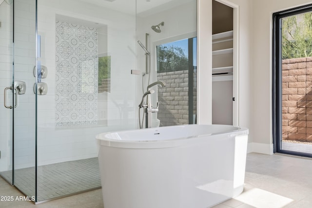 bathroom featuring tile patterned flooring and independent shower and bath