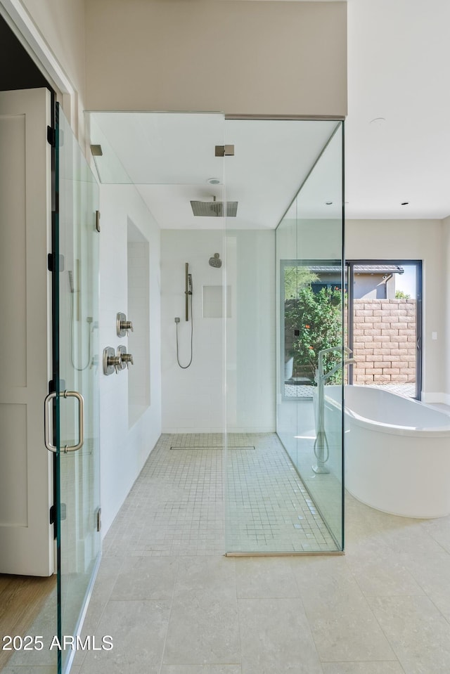 bathroom with tile patterned flooring and independent shower and bath