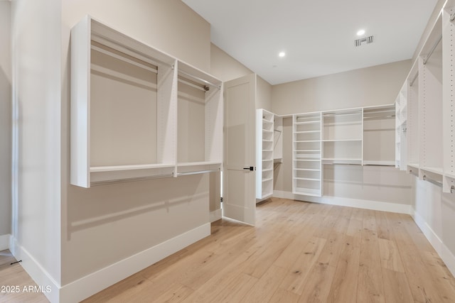 spacious closet featuring light wood-type flooring