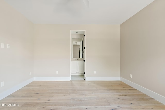 unfurnished room featuring light hardwood / wood-style floors and sink