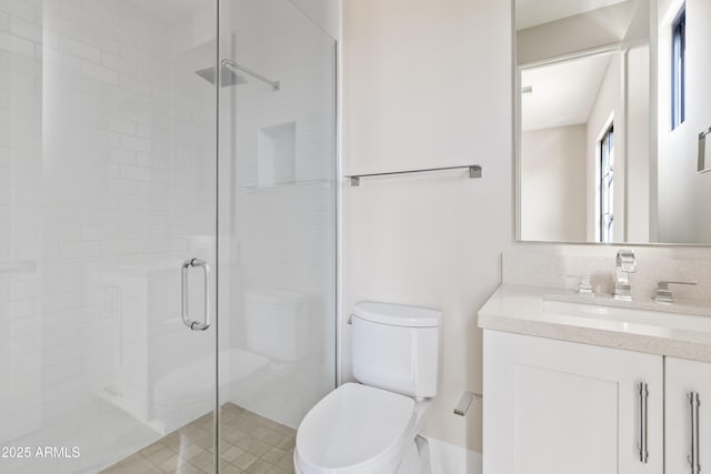 bathroom featuring vanity, an enclosed shower, and toilet