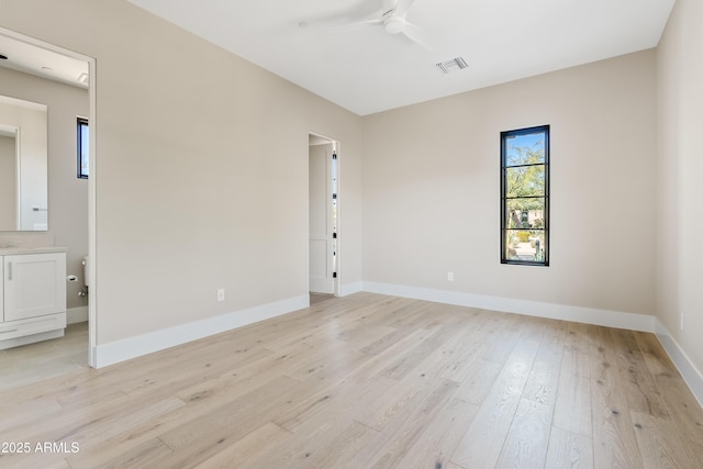 spare room featuring ceiling fan and light hardwood / wood-style floors