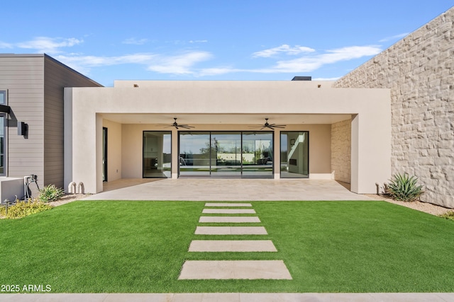 back of house with a lawn, ceiling fan, and a patio