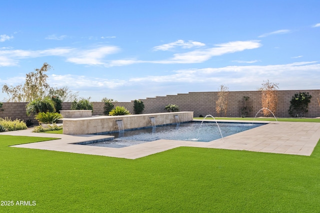 view of swimming pool featuring pool water feature, a patio area, and a lawn