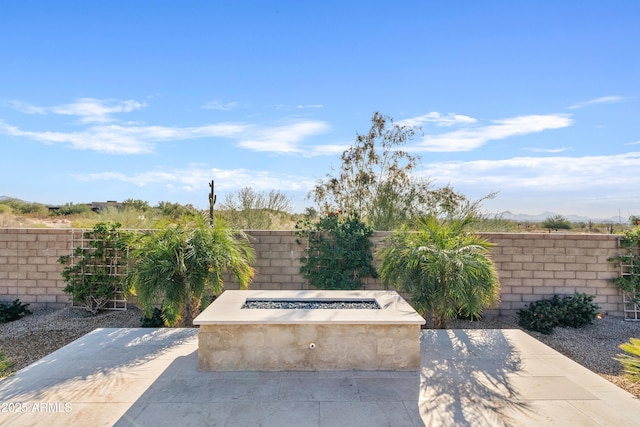 view of patio featuring an outdoor fire pit