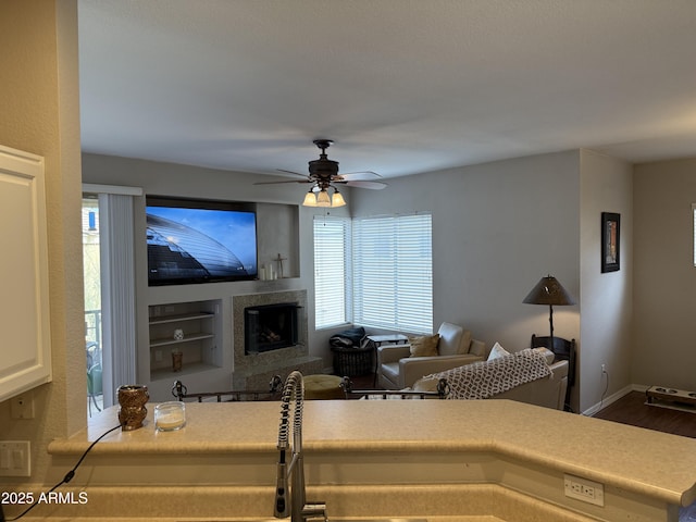 living room featuring dark wood-type flooring and ceiling fan