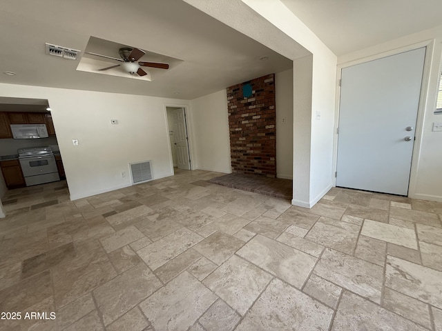 unfurnished living room with baseboards, visible vents, ceiling fan, and stone tile floors