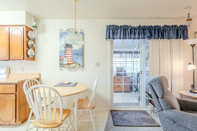 dining space with light tile patterned floors and baseboards