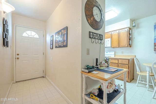 entryway featuring baseboards