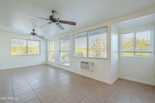 empty room featuring light tile patterned floors, baseboards, and a wall mounted AC