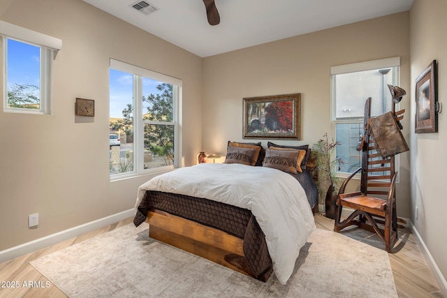 12311 E Black Rock Rd, Scottsdale, AZ 85255 - bedroom featuring multiple windows, baseboards, light wood-style flooring, and a ceiling fan
