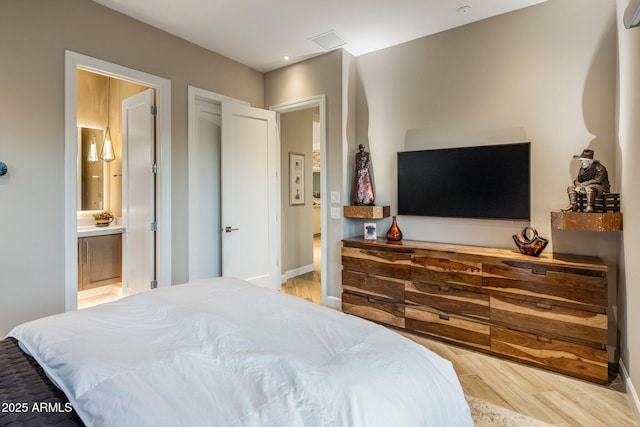 12311 E Black Rock Rd, Scottsdale, AZ 85255 - bedroom with light wood finished floors, connected bathroom, and baseboards