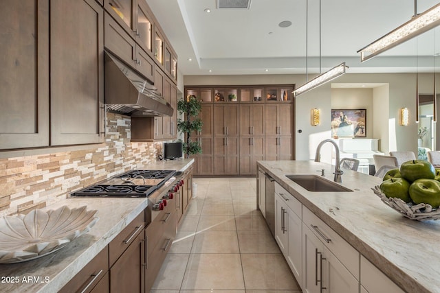 12311 E Black Rock Rd, Scottsdale, AZ 85255 - kitchen with a sink, appliances with stainless steel finishes, backsplash, light stone countertops, and glass insert cabinets