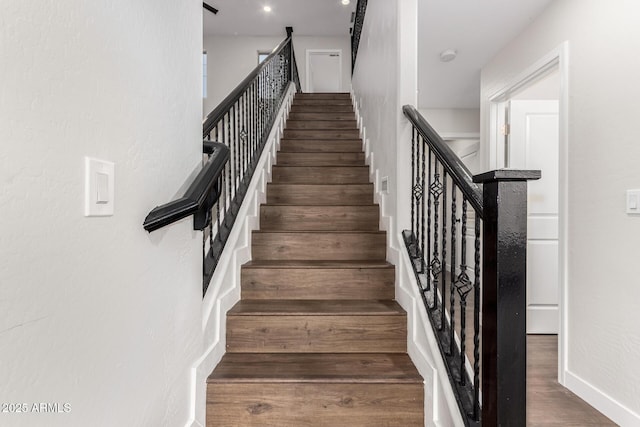 stairs featuring hardwood / wood-style floors