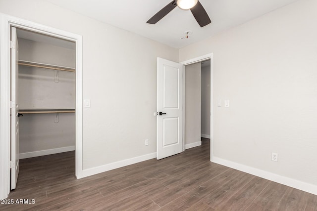 unfurnished bedroom featuring dark hardwood / wood-style flooring, a closet, and ceiling fan