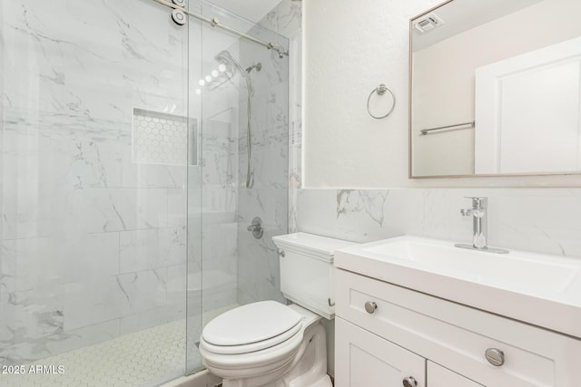 bathroom featuring walk in shower, tile walls, vanity, and toilet