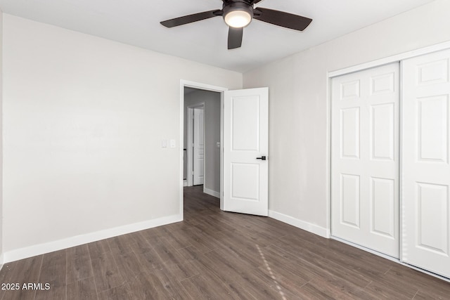 unfurnished bedroom with ceiling fan, dark hardwood / wood-style flooring, and a closet