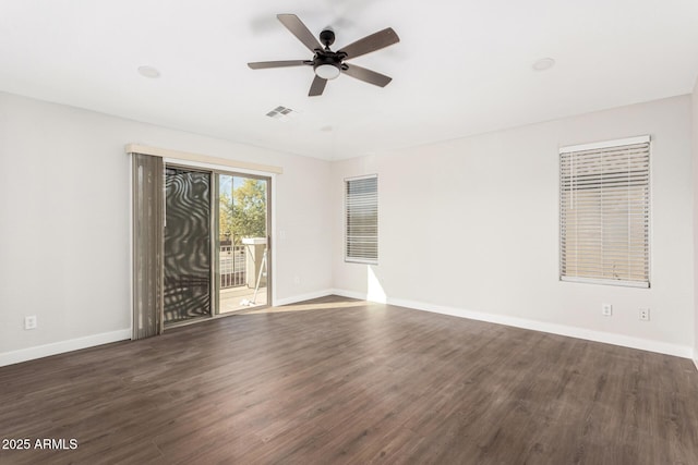 unfurnished room with dark wood-type flooring and ceiling fan