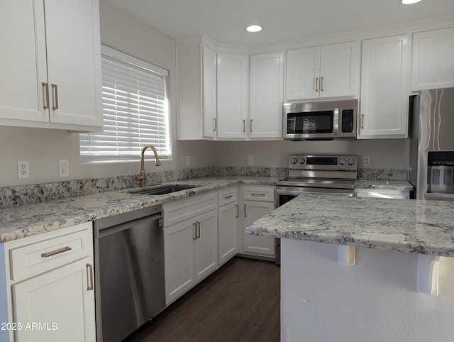 kitchen featuring sink, white cabinetry, stainless steel appliances, dark hardwood / wood-style floors, and light stone counters