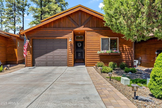 2540 W Waters Edge Ln, Lakeside, AZ 85929 - chalet / cabin with driveway, a garage, and board and batten siding
