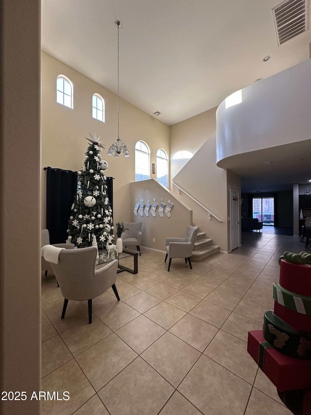 tiled living room featuring a towering ceiling