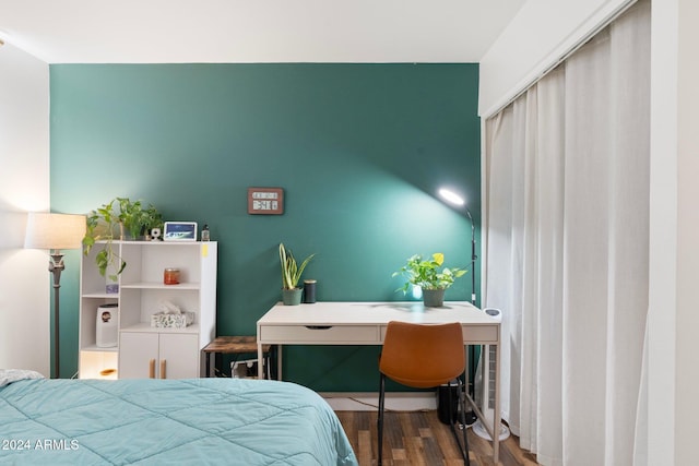 bedroom with dark hardwood / wood-style floors