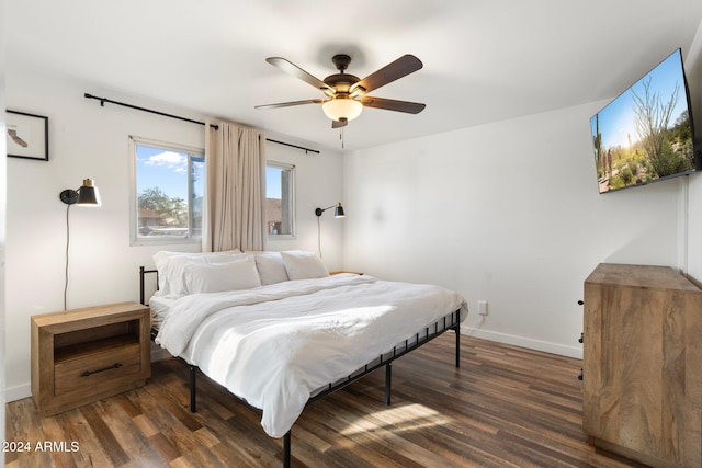 bedroom featuring dark hardwood / wood-style flooring and ceiling fan