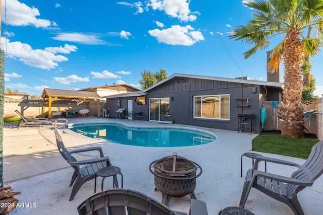 view of pool with a patio area and an outdoor fire pit