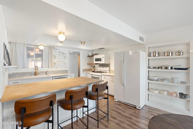 kitchen with white cabinets, light wood-type flooring, white appliances, and wooden counters