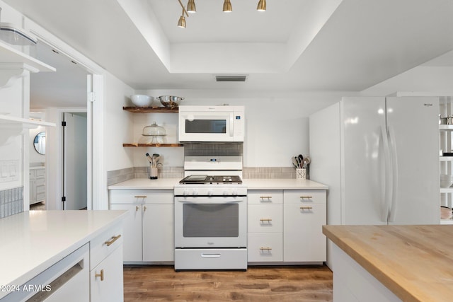 kitchen featuring white cabinetry, dark wood-type flooring, and white appliances