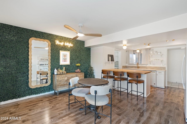 dining area with ceiling fan and hardwood / wood-style flooring