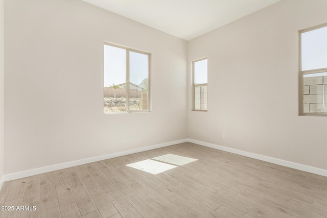 5664 N 205th Ln, Buckeye, AZ 85396 - unfurnished room with healthy amount of natural light, light wood-style floors, and baseboards