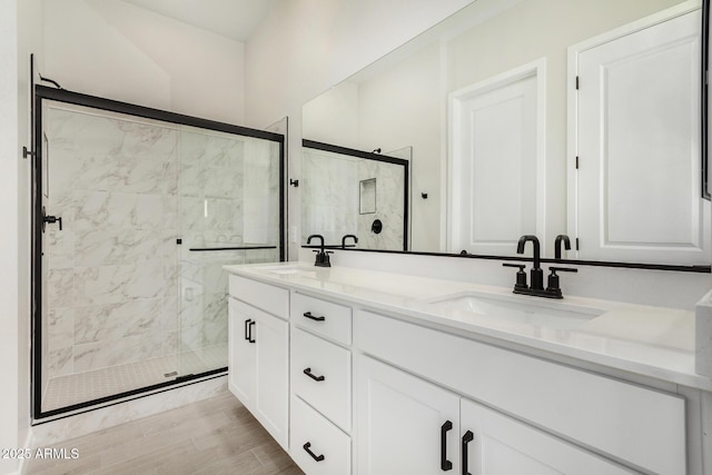 5664 N 205th Ln, Buckeye, AZ 85396 - full bath with a stall shower, double vanity, and wood finished floors