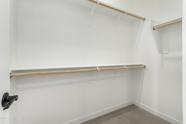 5664 N 205th Ln, Buckeye, AZ 85396 - spacious closet featuring wood finished floors