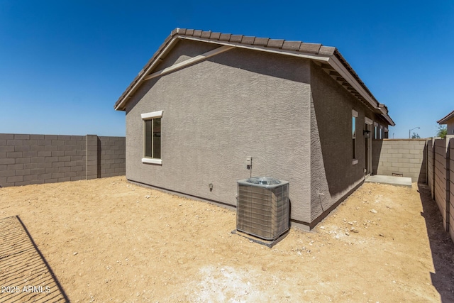5664 N 205th Ln, Buckeye, AZ 85396 - view of property exterior featuring stucco siding, a fenced backyard, and central air condition unit