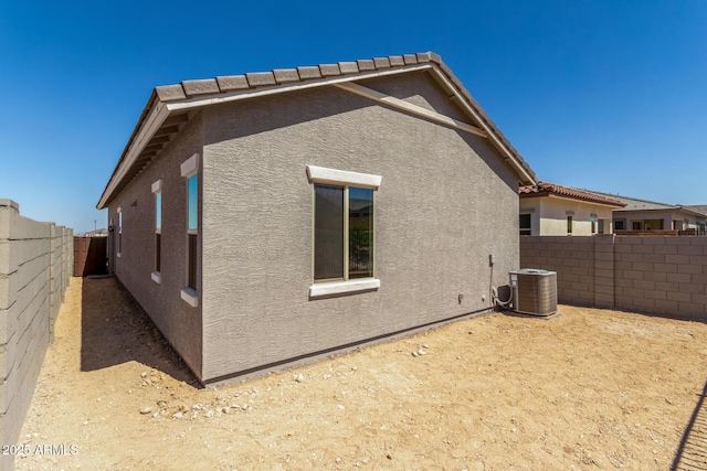 5664 N 205th Ln, Buckeye, AZ 85396 - view of home's exterior with stucco siding, cooling unit, and a fenced backyard