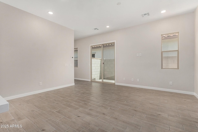 5664 N 205th Ln, Buckeye, AZ 85396 - empty room featuring light wood-type flooring, baseboards, and recessed lighting