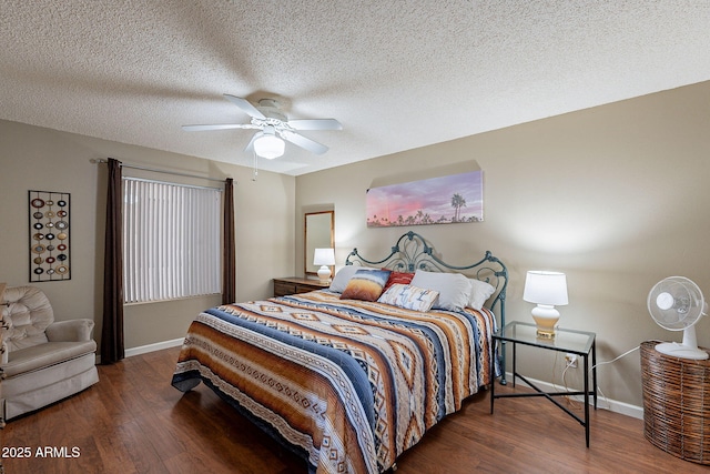 bedroom with ceiling fan, dark wood-type flooring, and a textured ceiling