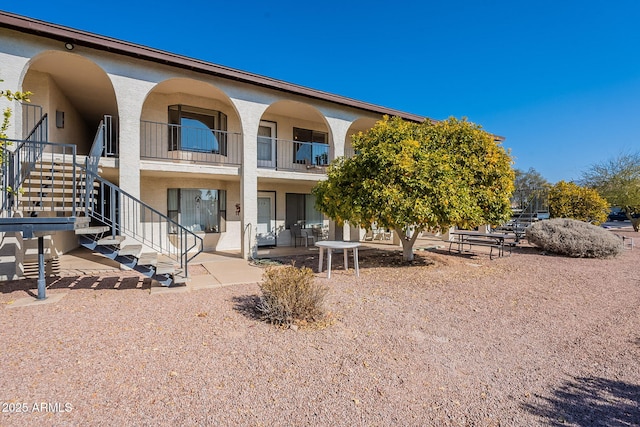 rear view of property featuring a patio area