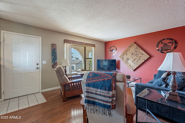 living room featuring hardwood / wood-style floors and a textured ceiling