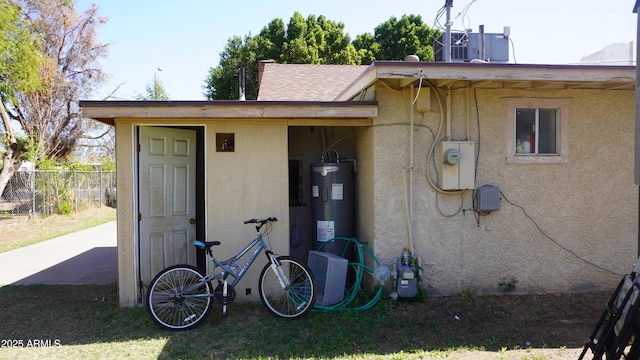 view of outbuilding with central air condition unit and fence