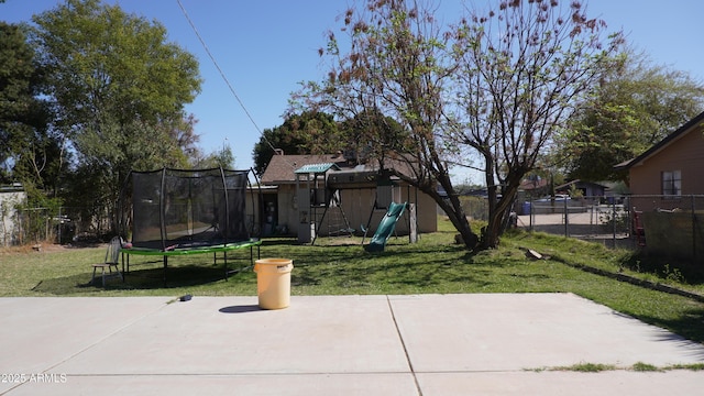 view of yard featuring a fenced backyard, a patio, a playground, and a trampoline